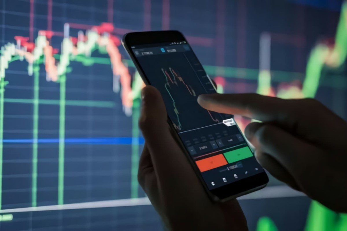 Ilustração de um mão com o celular verificando gráficos do Ibovespa mercado financeiro