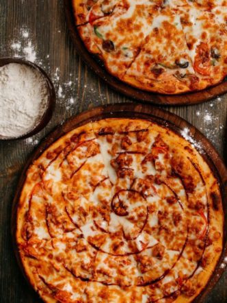 front-view-pizza-with-cheese-wooden-rustic-floor