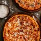 front-view-pizza-with-cheese-wooden-rustic-floor